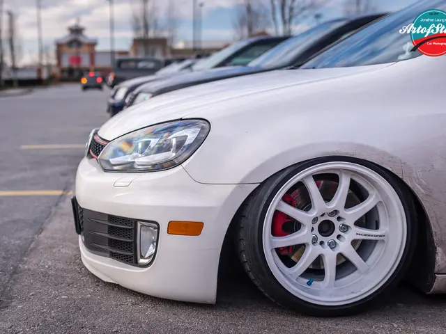 On the right side there are cars on a road, in the background there are trees, building and the sky...